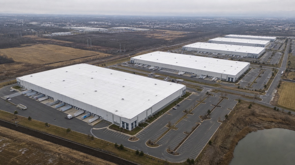 Aerial view of multiple warehouse roofs under long-term factory warranty